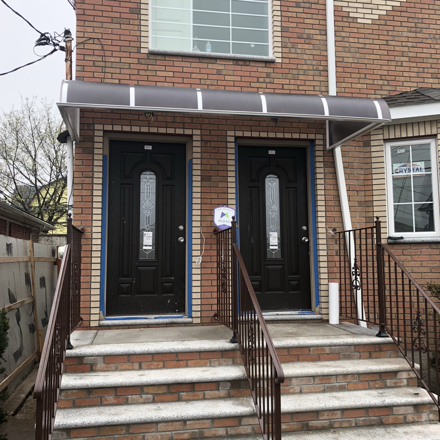 Brick entry with dark awning