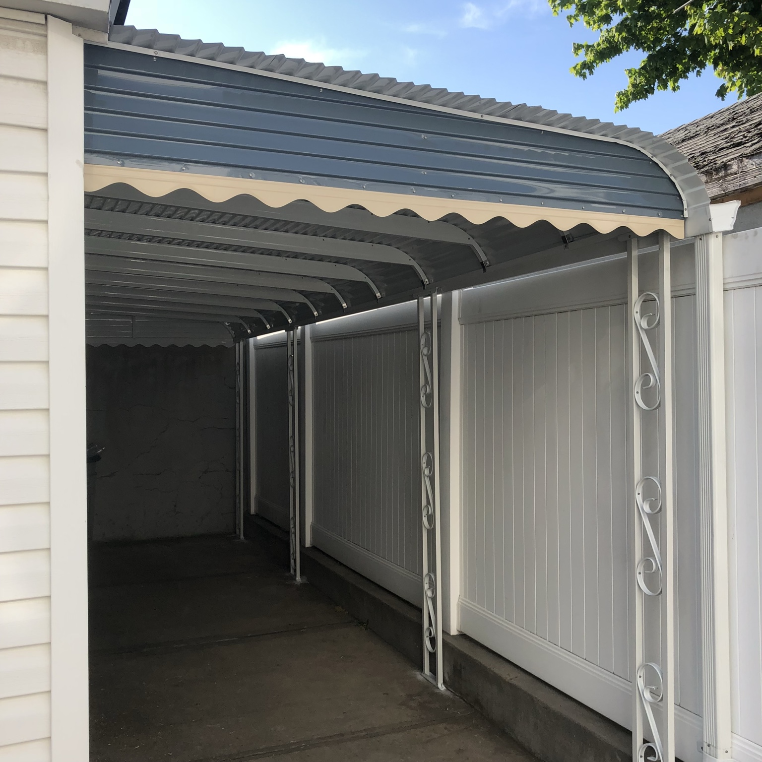 Aluminum awning and covered side area by a home