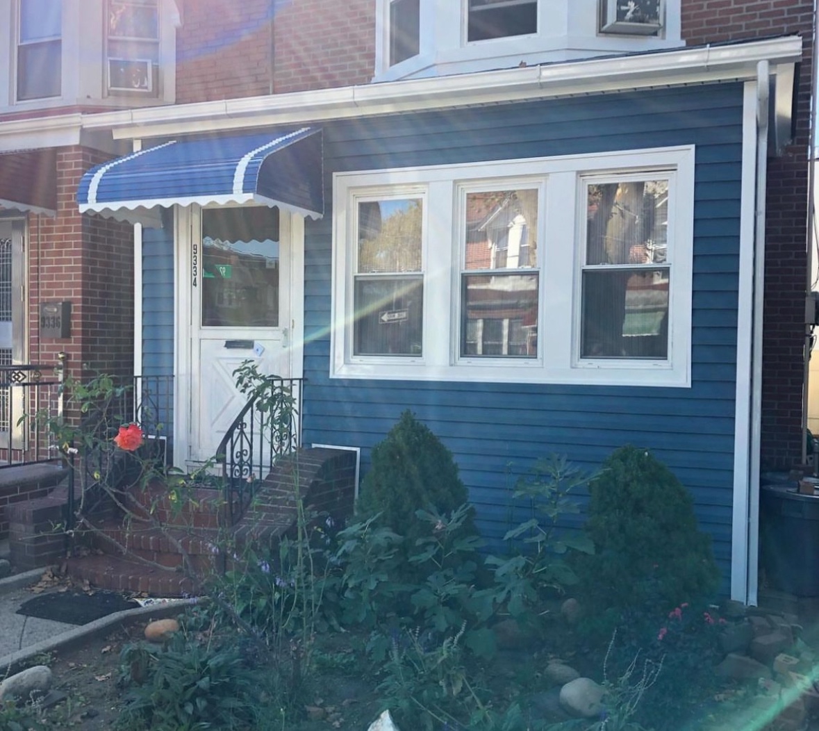 Blue and white fabric awnings on residential windows