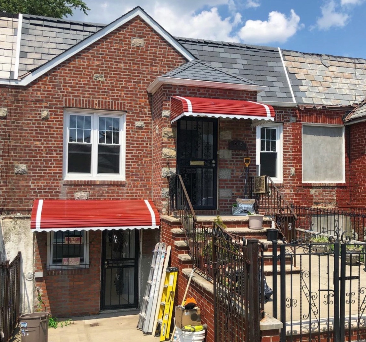 Brick home with red awnings