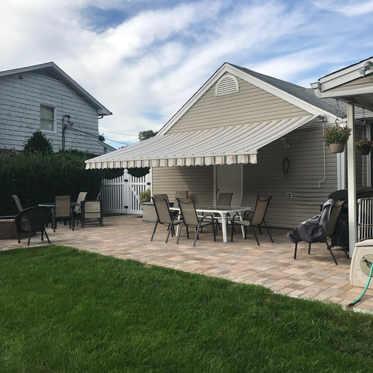 Fabric patio awning over backyard seating area