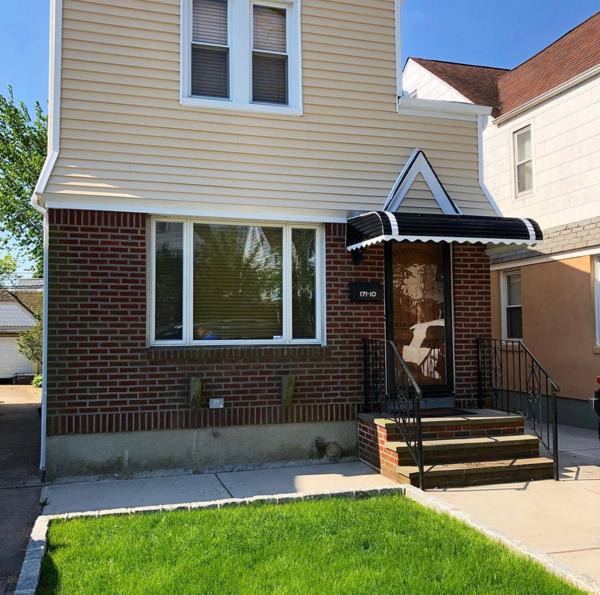 Home front door with dark awning