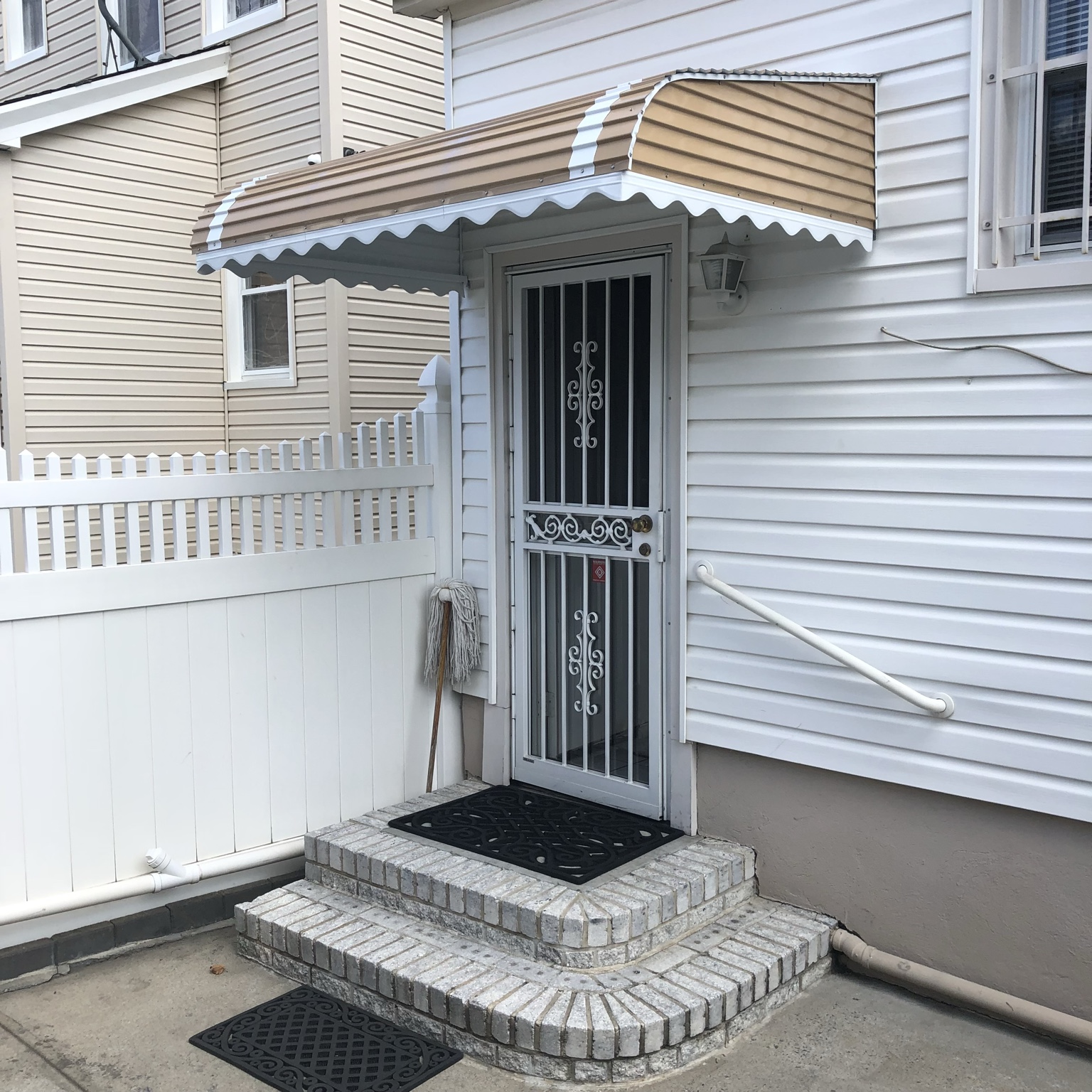 Striped door awning on residential entrance